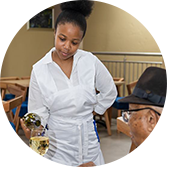 Image shows a waitress serving wine to a customer at the Isijula Boutique Hotel in Westonaria